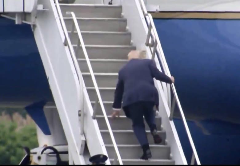 Donald Trump falls on the stairs while boarding Air Force One.